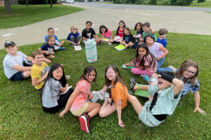 students sitting outside in a circle